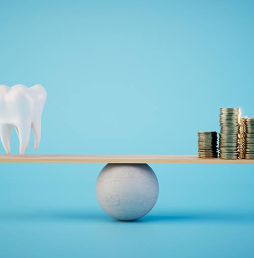 a model of a tooth and a stack of coins