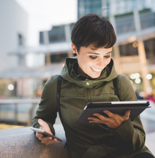 Smiling woman looking at a tablet screen